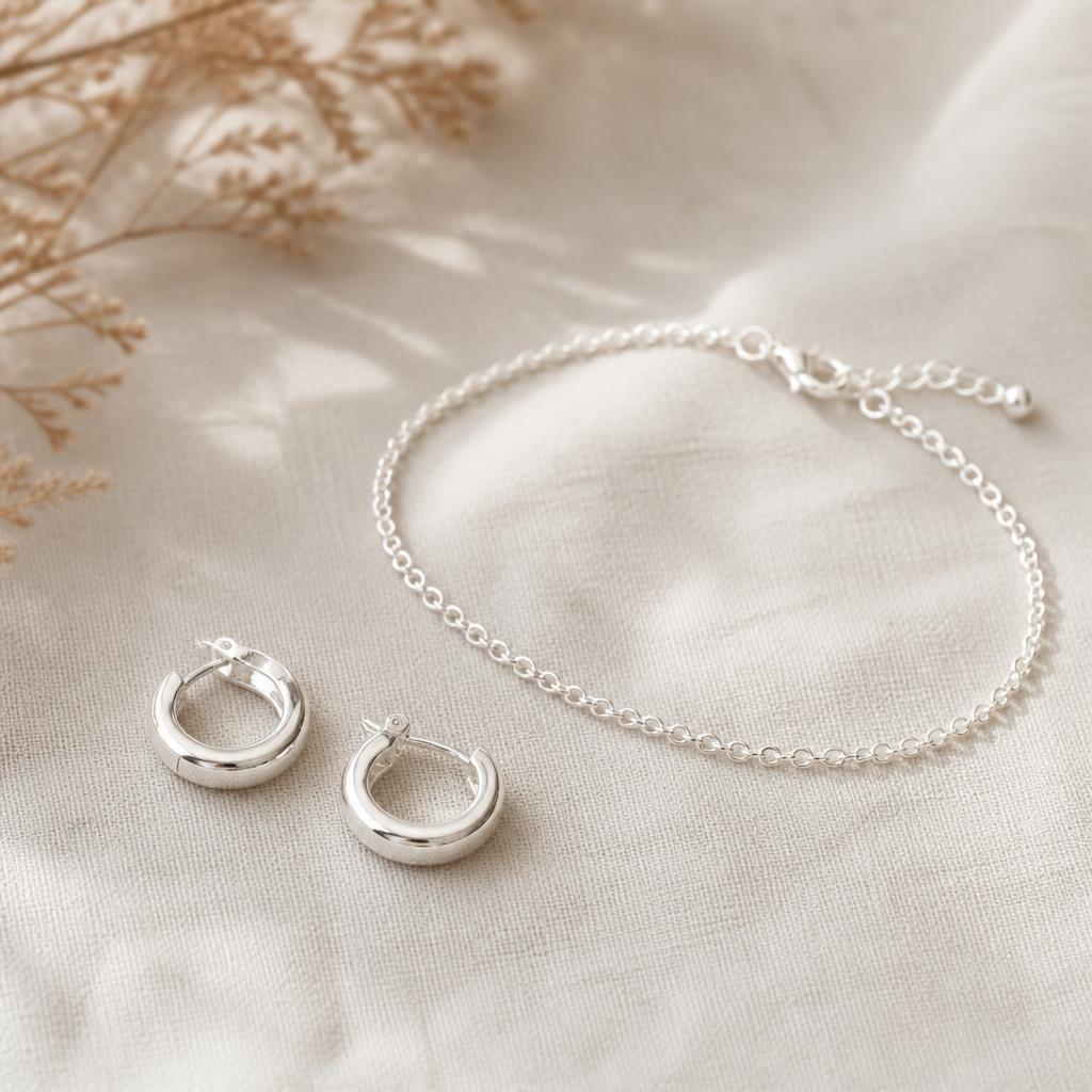 Minimalist silver huggie hoop earrings and thin silver bracelet