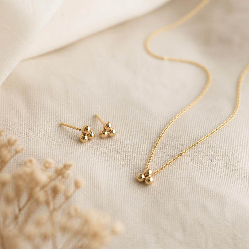 Dainty yellow gold stud earrings and matching fine chain necklace