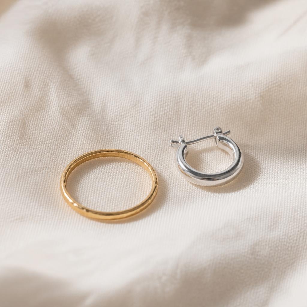 Yellow gold stacking ring and small silver hoop earring