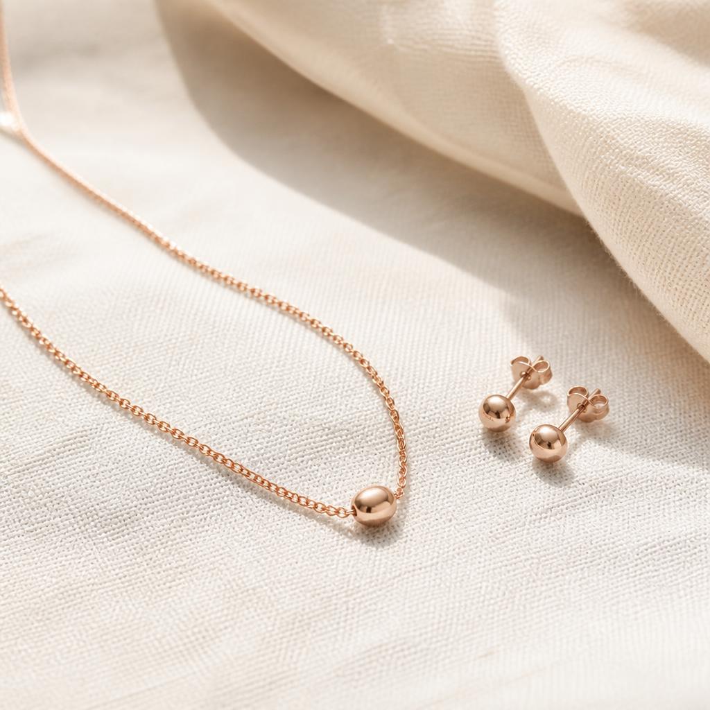 Dainty rose gold necklace and matching tiny stud earrings