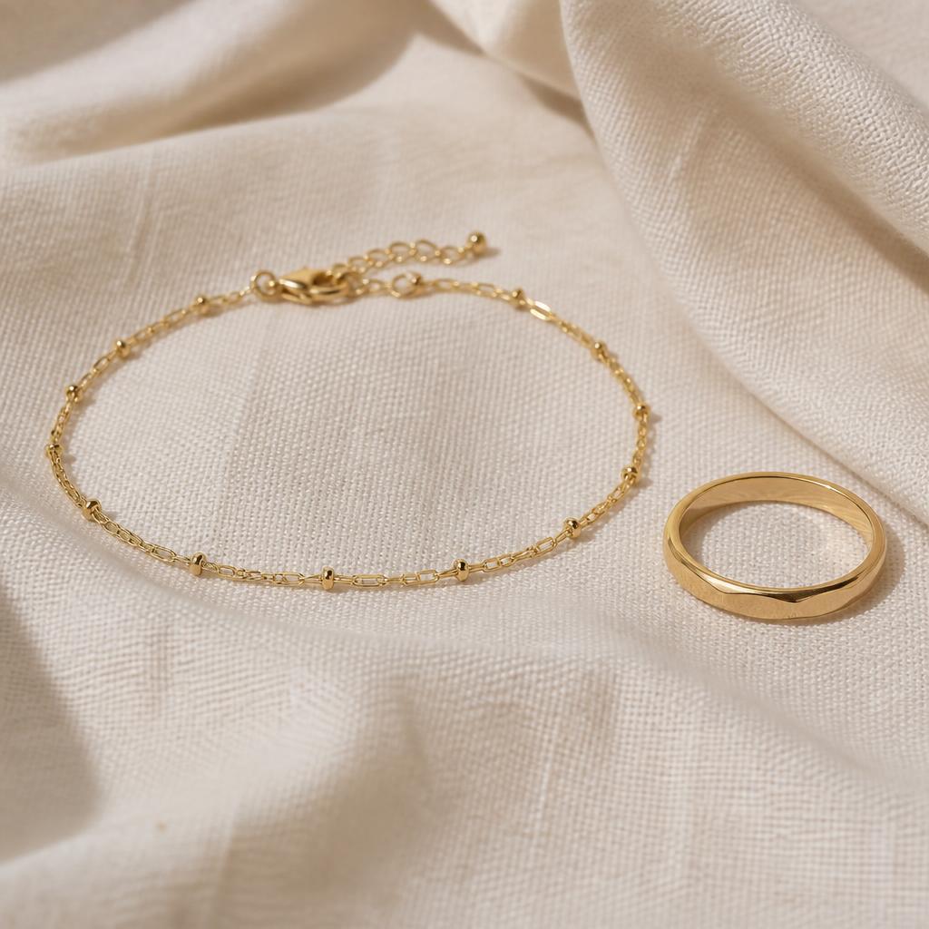 Yellow gold beaded chain bracelet and simple gold band ring