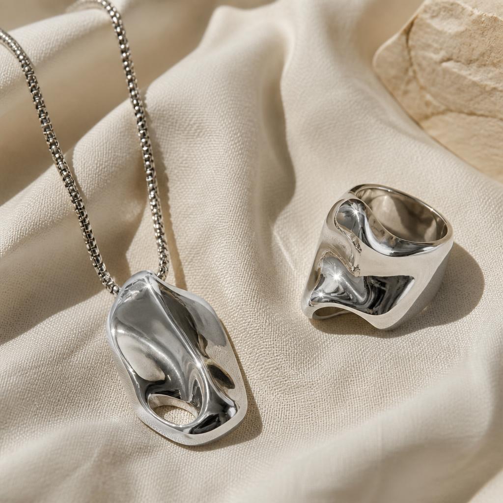 Bold silver sculptural pendant necklace and chunky silver ring