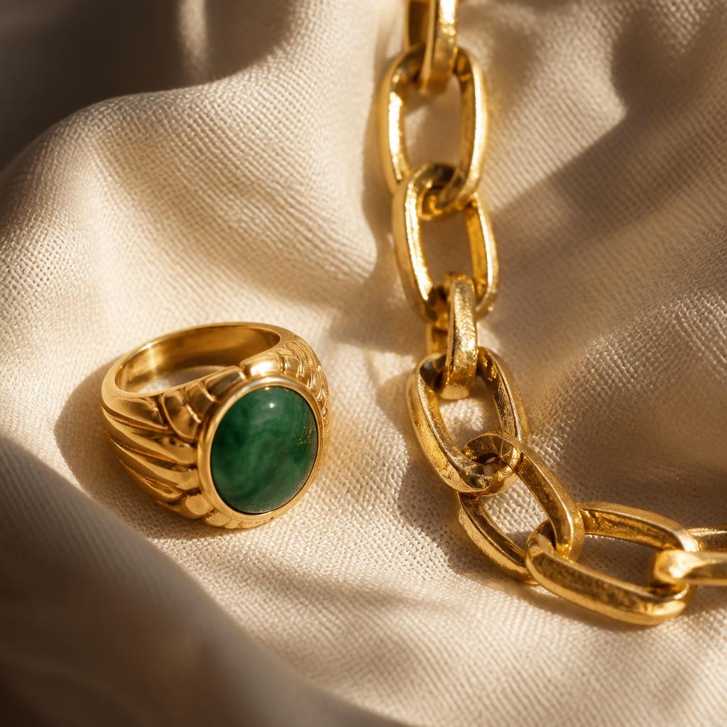 Statement yellow gold ring with green stone and chunky gold chain