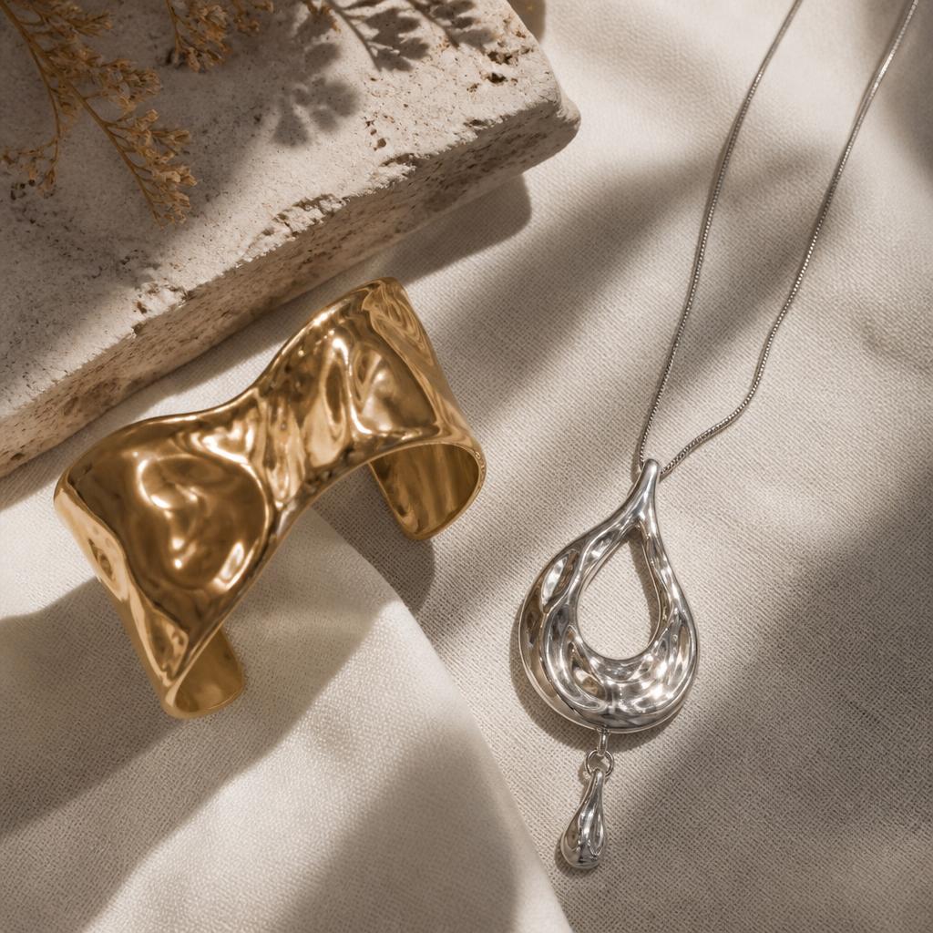Mixed metal statement set: gold cuff bracelet and silver sculptural pendant